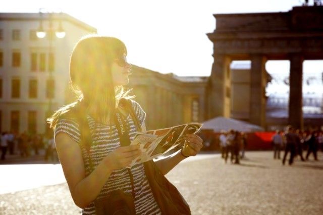 [Photo of female tourist with a map. You need a Toad Data Modeler map.]